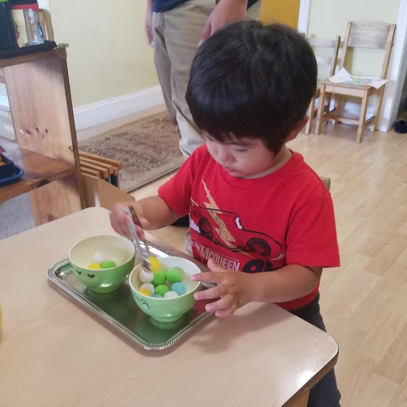 Child demonstrating inner drive and focus with Montessori materials